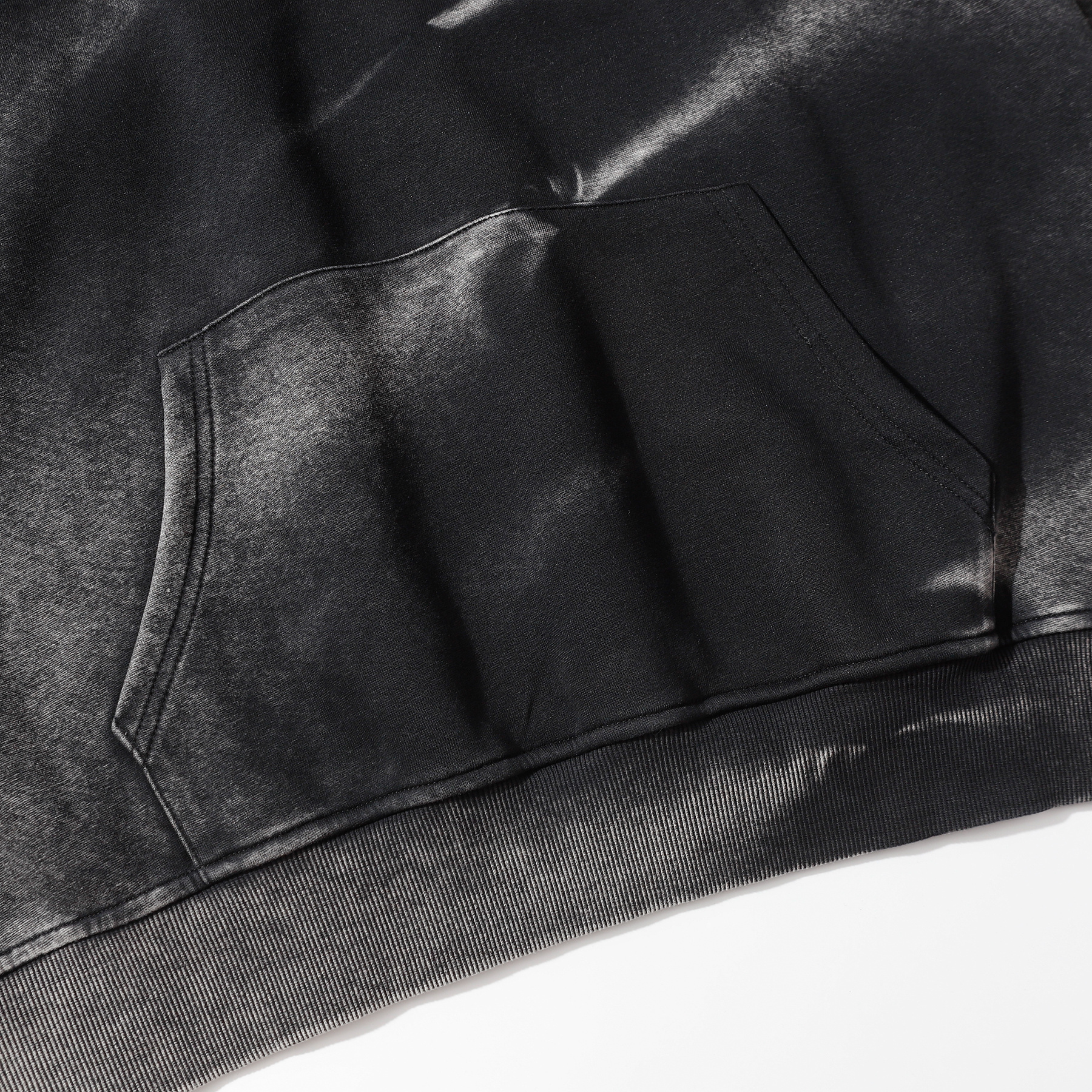 Close-up of dark gray vintage wash pullover hoodie front pocket detail, heavyweight cotton custom apparel