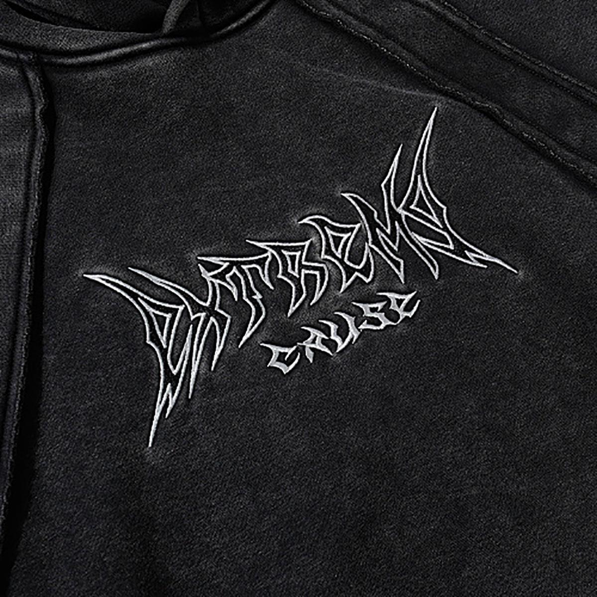 Close-up of men's black heavyweight hoodie embroidery detail, vintage streetwear