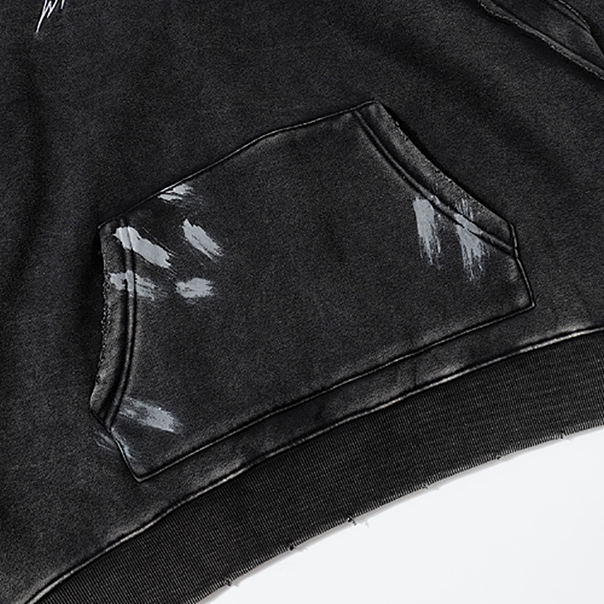 Close-up of men's black heavyweight hoodie pocket detail, vintage streetwear
