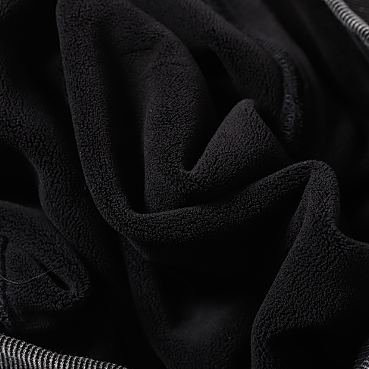 Close-up of men's black heavyweight double-zip hooded fleece zip-up jacket, showing soft fleece inner lining detail
