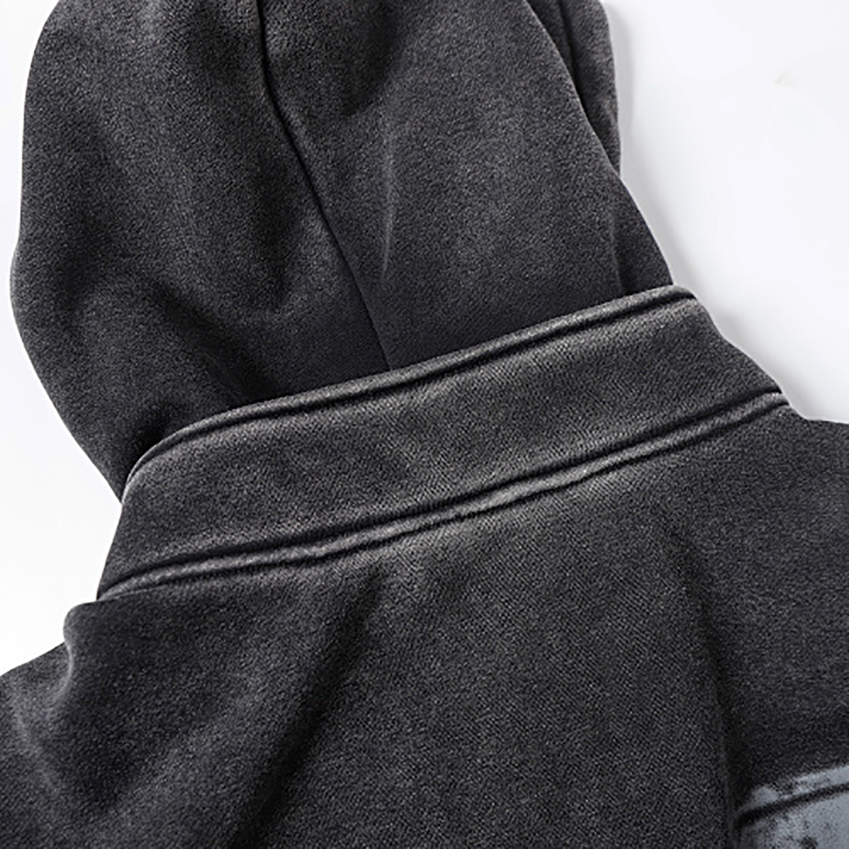 Close-up of men's black heavyweight double-zip hooded fleece zip-up jacket, showing hood and collar detail