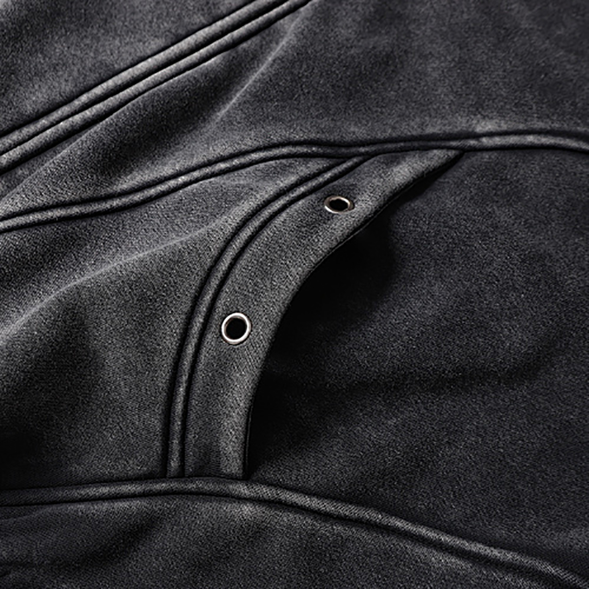 Close-up of men's black heavyweight double-zip hooded fleece zip-up jacket, showing pocket and eyelet detail