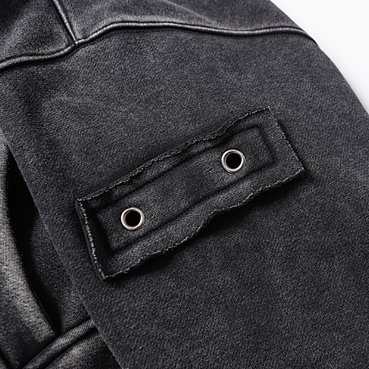 Close-up of men's black heavyweight double-zip hooded fleece zip-up jacket, showing sleeve pocket and eyelet detail
