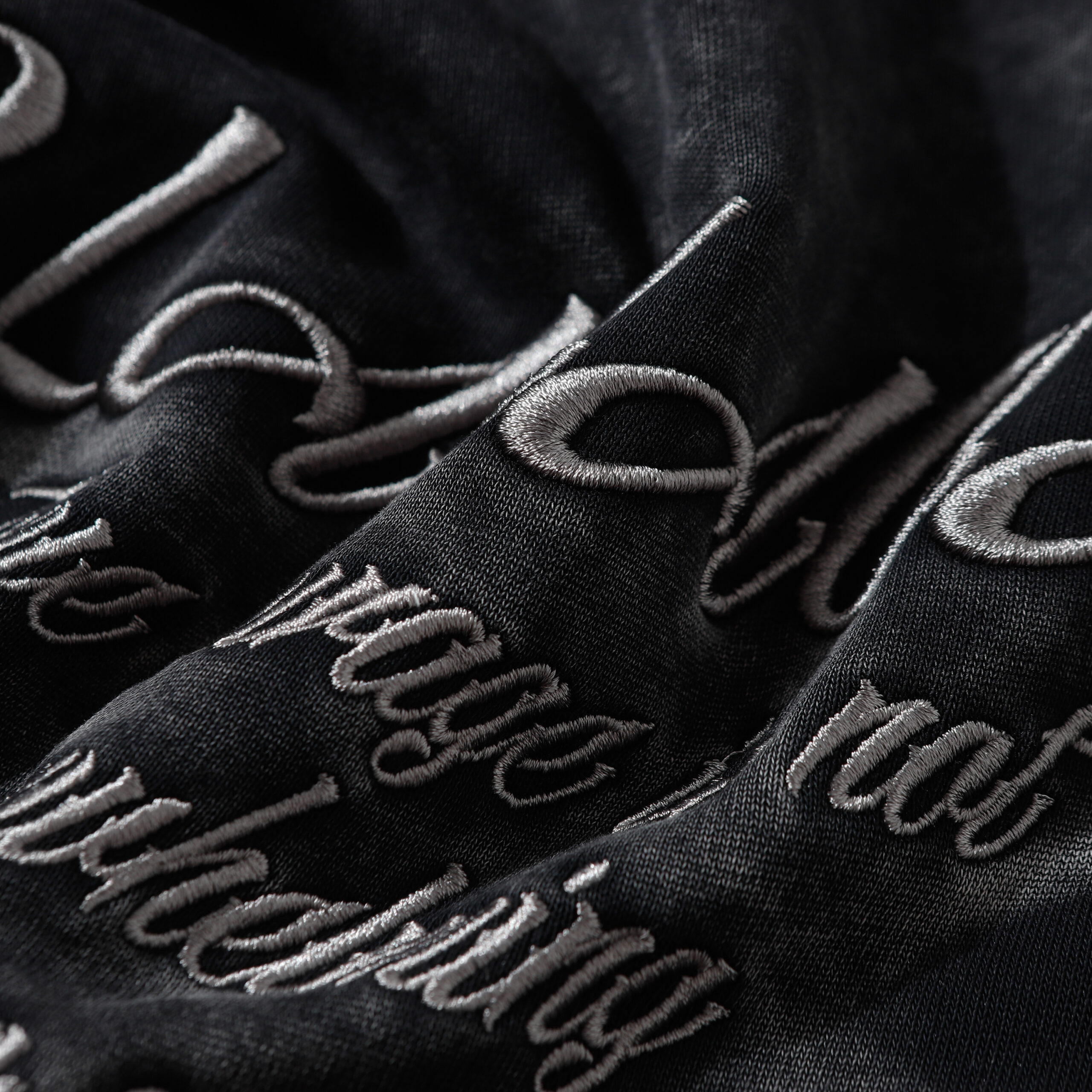 Embroidered hoodie letter embroidery detail, custom text embroidery on hoodie, premium thread stitching detail, streetwear hoodie embroidery craftsmanship, custom logo hoodie OEM