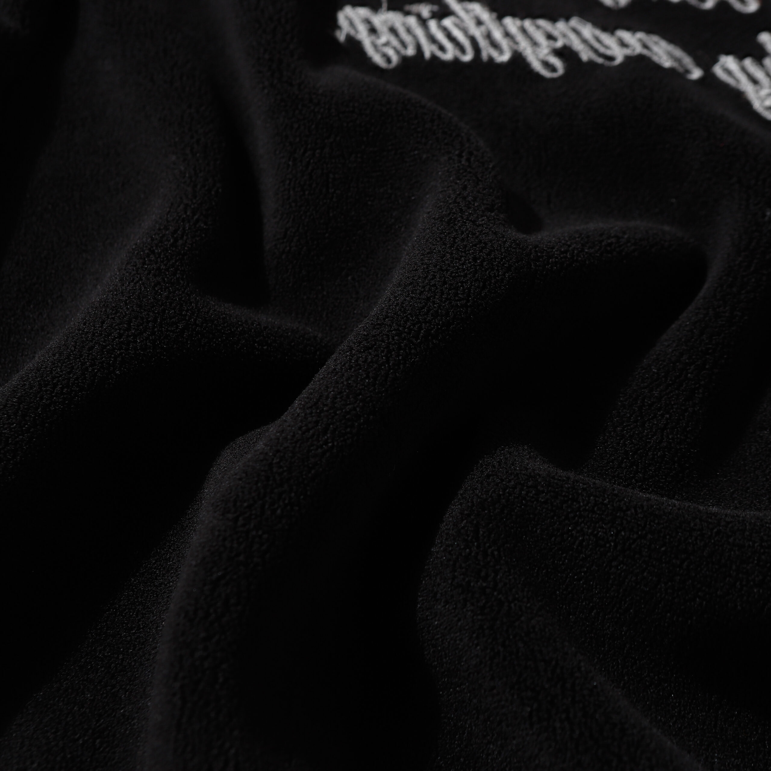Embroidered hoodie fabric texture close-up, premium heavyweight cotton hoodie material, acid wash hoodie fabric detail, soft fleece lined hoodie fabric, streetwear hoodie material quality