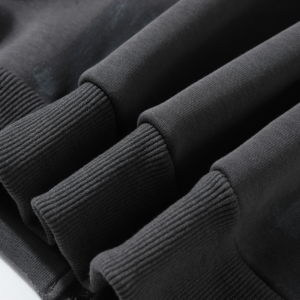 Close-up of men's gray American retro graffiti print fleece zip-up stand collar jacket, showing ribbed cuff/hem detail