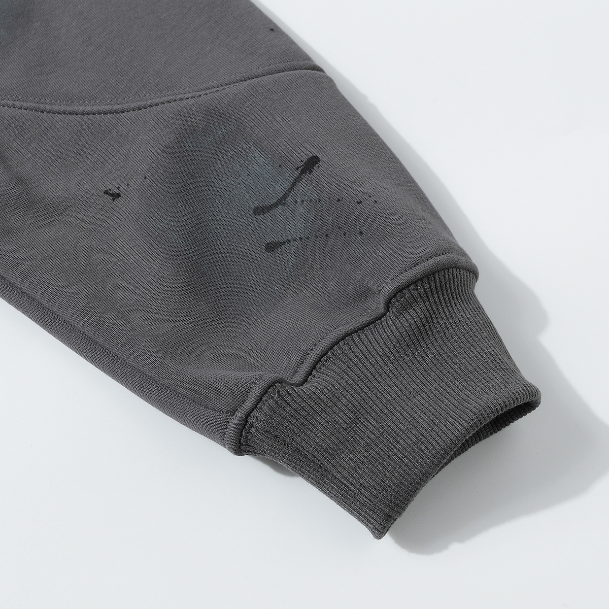 Close-up of men's gray American retro graffiti print fleece zip-up stand collar jacket, showing cuff detail