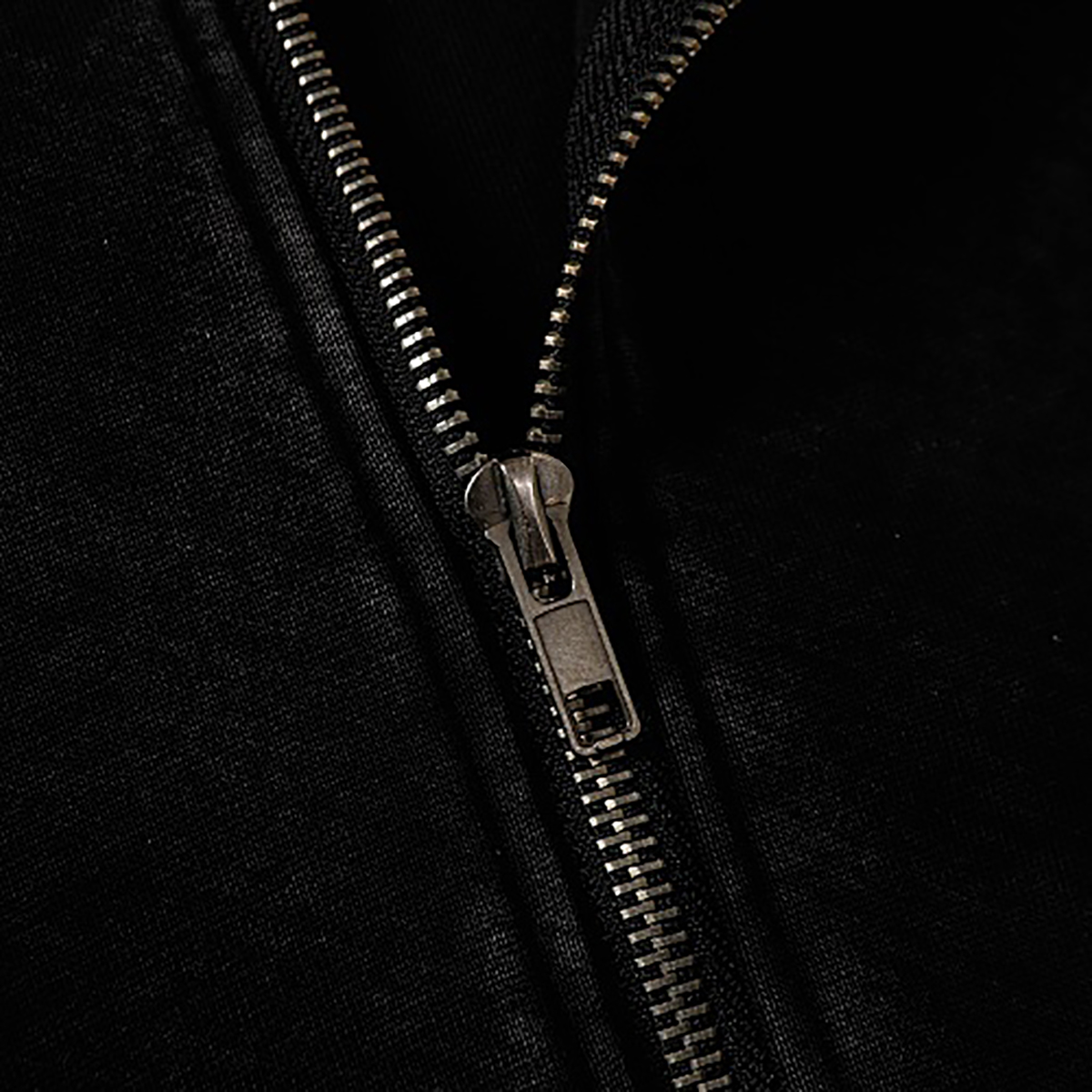 Close-up of zipper details on black high street spray-painted distressed zip-up hoodie