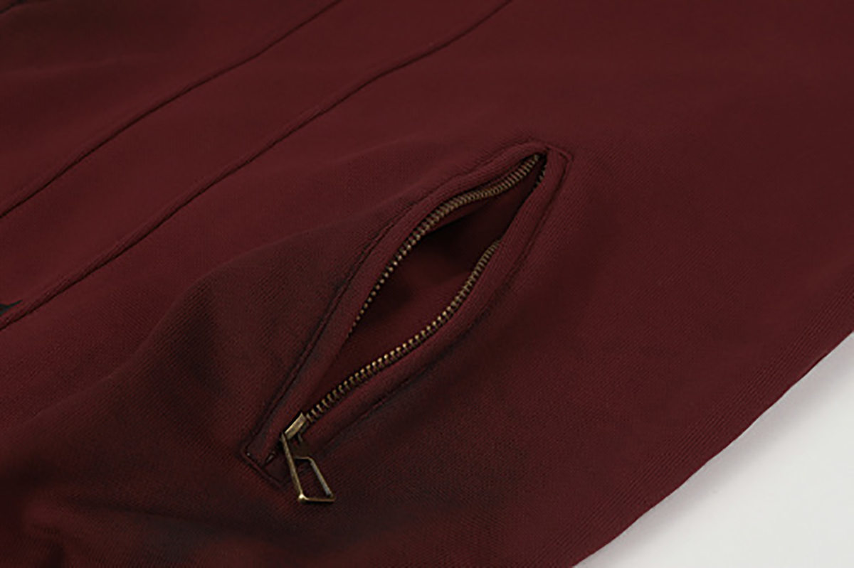 Close-up of burgundy hooded zip-up sweatshirt showing side zipper pocket detail