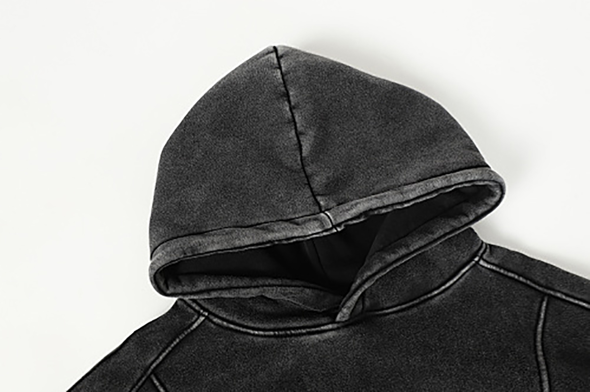Close-up of men's black American heavyweight vintage deconstructed patchwork fleece-lined hoodie, showing hood detail