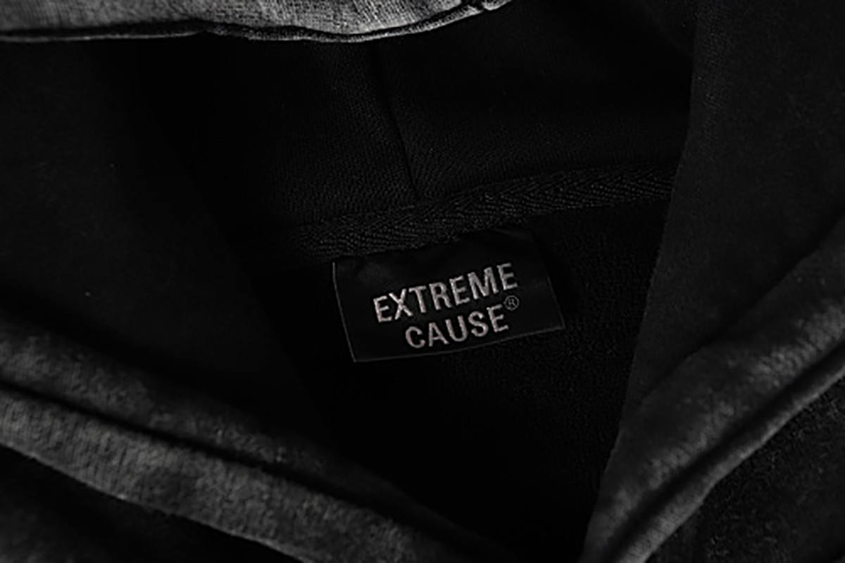 Close-up of men's black American heavyweight vintage deconstructed patchwork fleece-lined hoodie, showing inner brand label detail