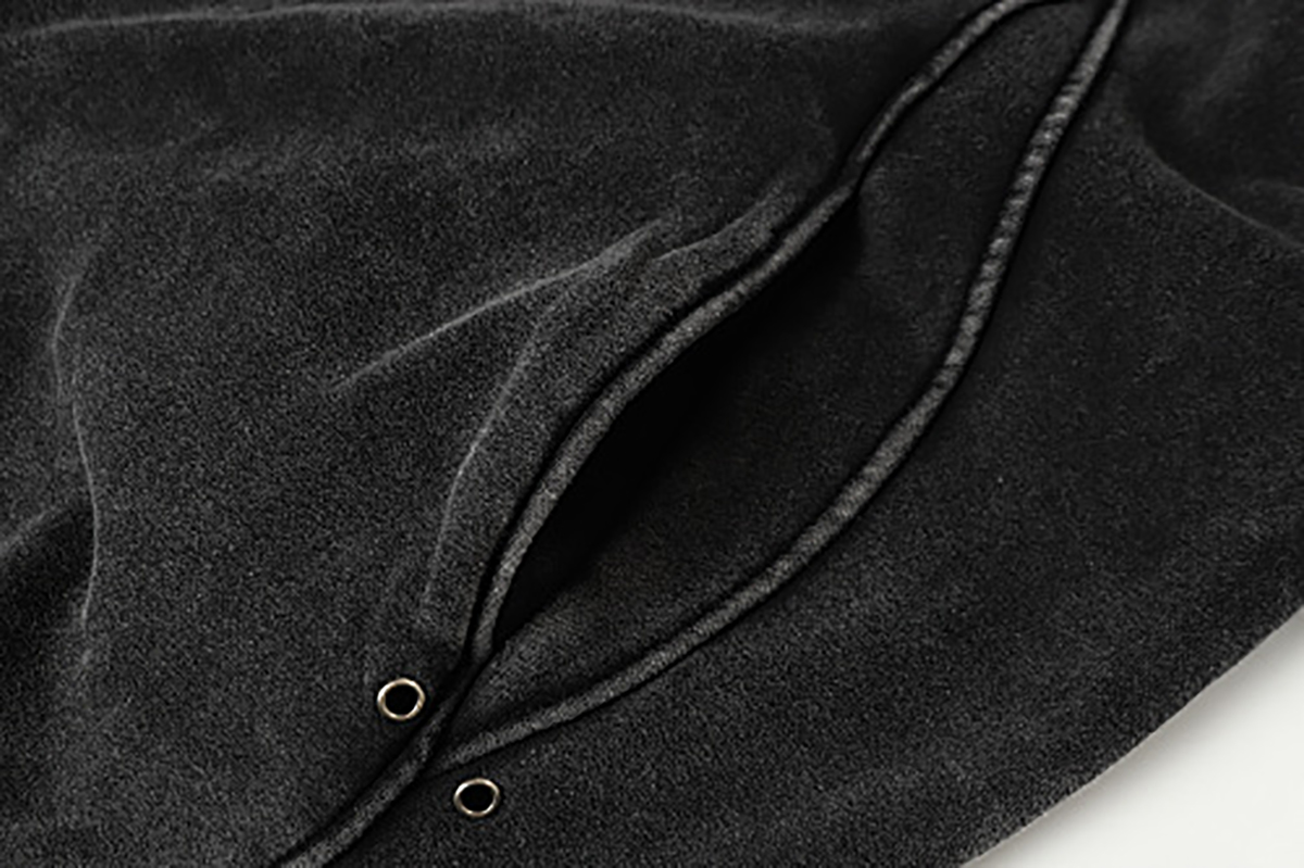 Close-up of men's black American heavyweight vintage deconstructed patchwork fleece-lined hoodie, showing pocket detail