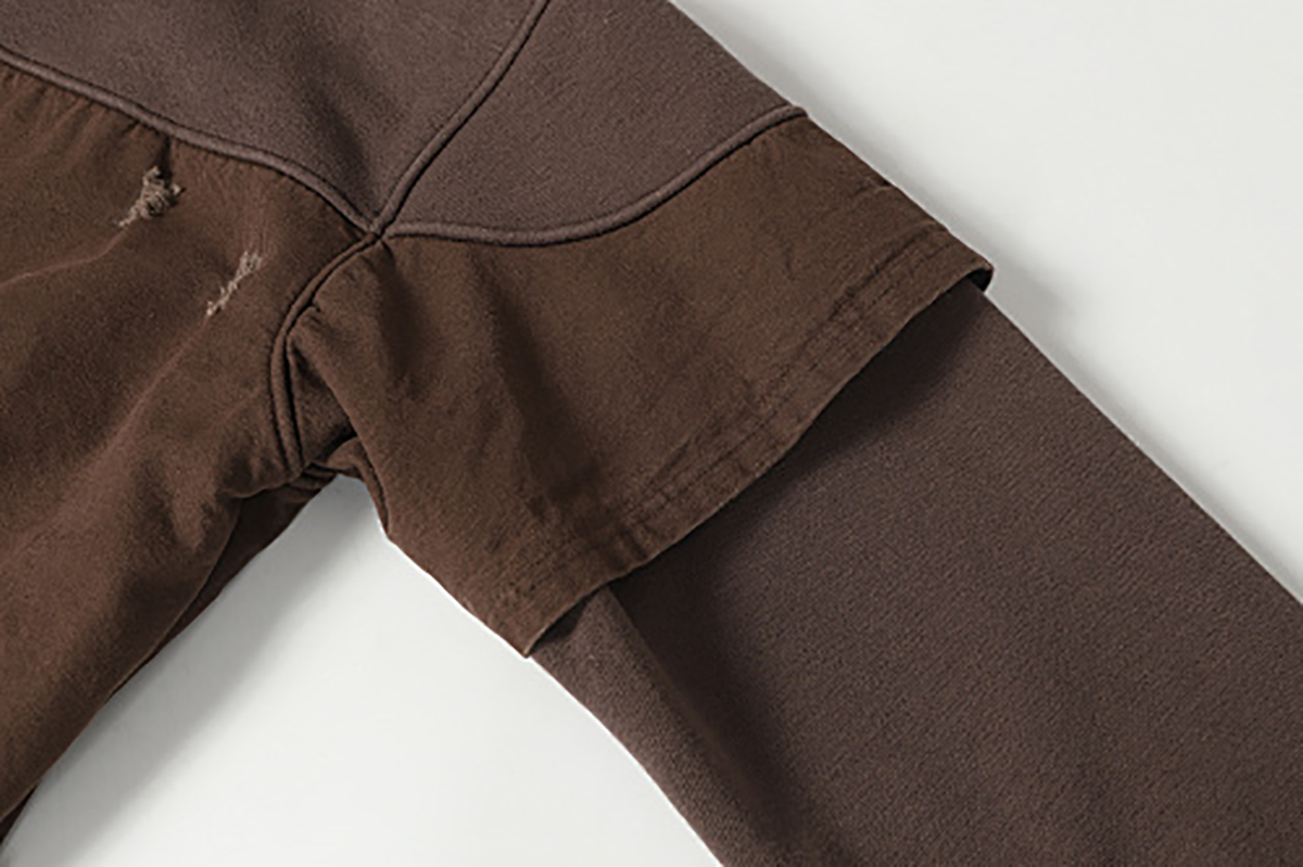 Close-up of men's coffee brown American retro patchwork hooded sweatshirt, showing shoulder and sleeve cuff detail