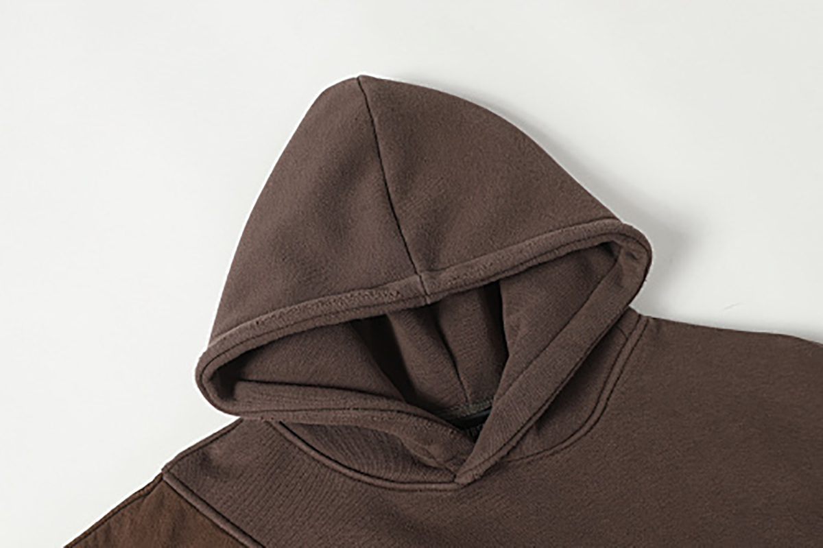 Close-up of men's coffee brown American retro patchwork hooded sweatshirt, showing hood detail