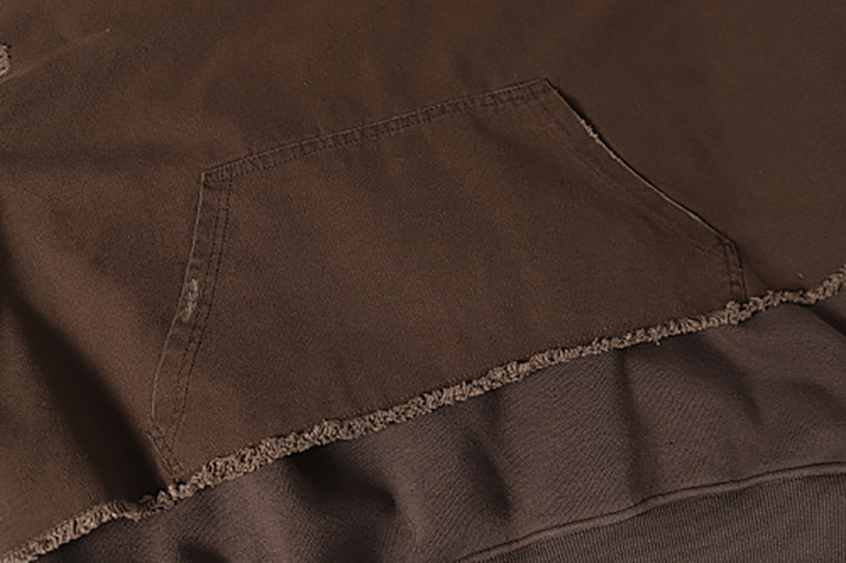 Close-up of men's coffee brown American retro patchwork hooded sweatshirt, showing frayed edge detail