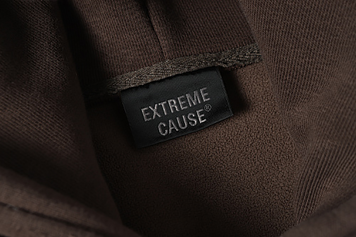 Close-up of men's coffee brown American retro patchwork hooded sweatshirt, showing inner brand label detail
