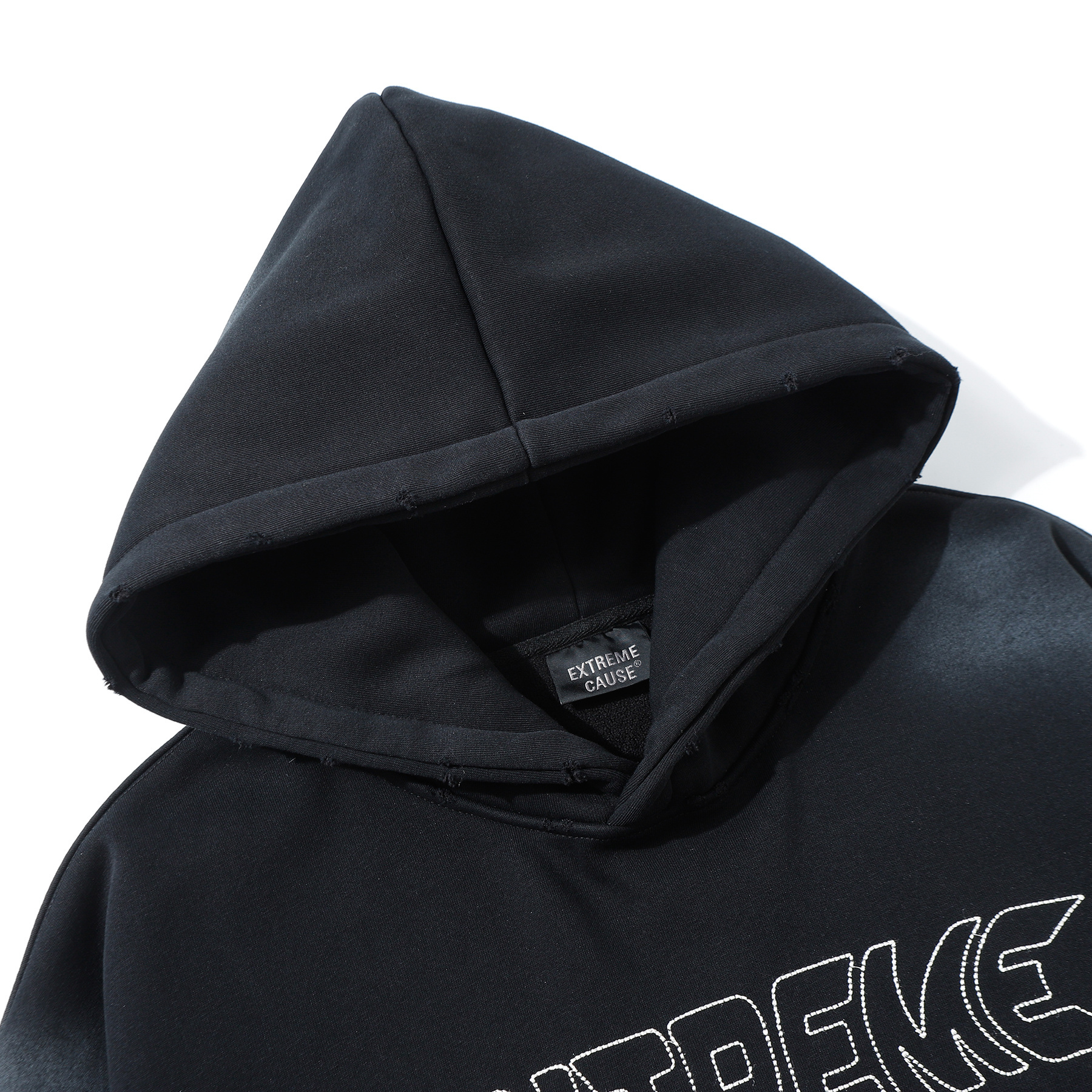 Close-up of black hoodie hood and chest embroidery detail