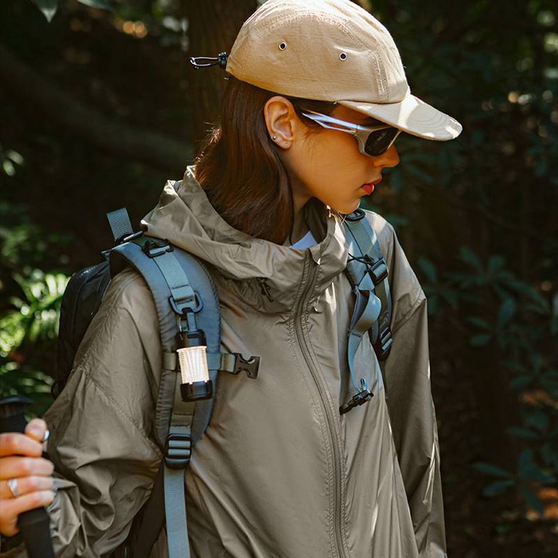 Woman wearing taupe hiking jacket outdoors